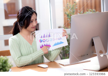 Young asian businesswoman sitting video call for presenting finance in home office. 123393966