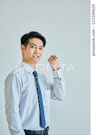 A young man in a dress shirt making a fist pump A young man in a dress shirt making a fist pump 123394029