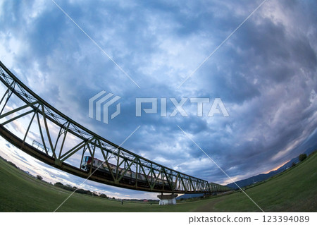 [Kotoku Line] Limited express train crossing the Yoshino River Bridge at dusk 123394089