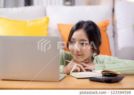 Young asian woman planning and strategy about finance and investment or tax. Young asian woman planning and strategy about finance and investment or tax. 123394599