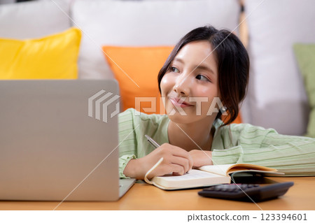 Young asian woman planning and strategy about finance and investment or tax. Young asian woman planning and strategy about finance and investment or tax. 123394601