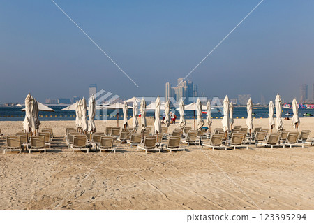 Rows of sun loungers for tourists are displayed against the backdrop of the sea 123395294