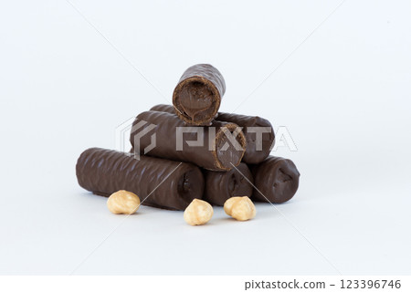 Sweet chocolate covered rolls - table arrangement, isolated on white background. Selective focus. Copy space. Sweet chocolate covered rolls - table arrangement, isolated on white background. Selective focus. Copy space. 123396746
