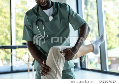 African american physical therapist and a female patient in the rehabilitation center African american physical therapist and a female patient in the rehabilitation center 123397052