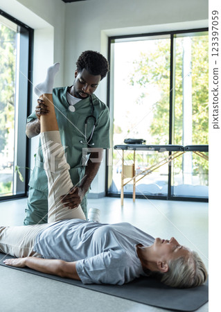 African american physical therapist working with a female patient 123397059