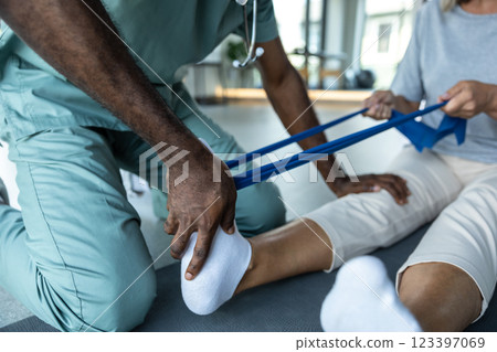 African american physical therapist working with a female patient African american physical therapist working with a female patient 123397069