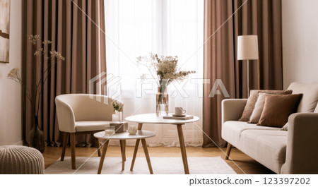 Cozy modern living room with neutral tones and elegant furniture featuring natural light 123397202