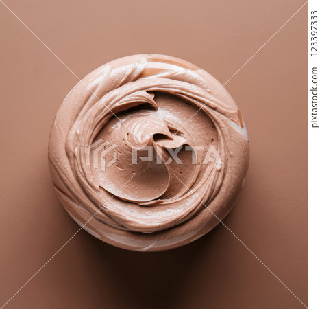 Top view of smooth brown swirled chocolate cream on circular surface 123397333