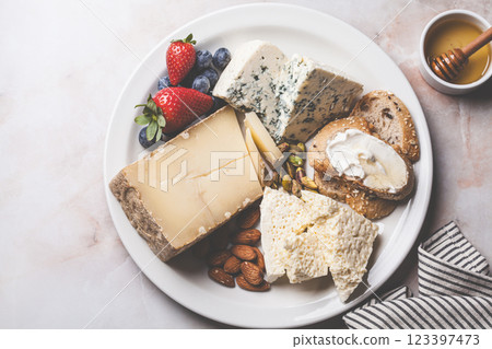 Cheese plate for party with honey, nuts and berries. Cheese plate for party with honey, nuts and berries. 123397473