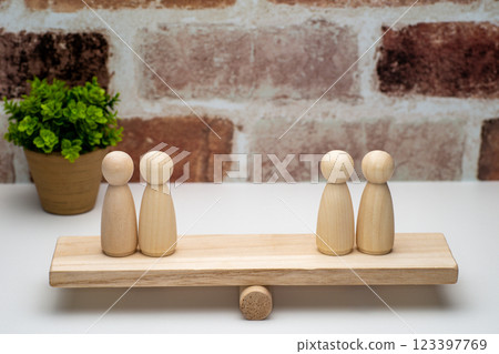 Two peg dolls on a seesaw Two peg dolls on a seesaw 123397769