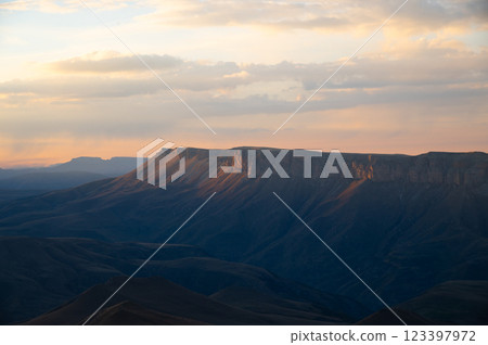 Beautiful sea of clouds in the morning in the mountains. Rocky mountains with cliffs covered with thick clouds after sunset Beautiful sea of clouds in the morning in the mountains. Rocky mountains with cliffs covered with thick clouds after sunset 123397972