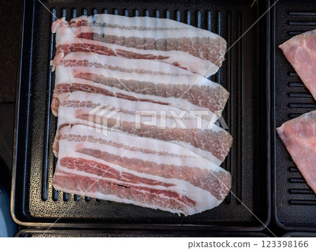 Sliced belly pork for shabu or Japanese hot pot on black tray Sliced belly pork for shabu or Japanese hot pot on black tray 123398166