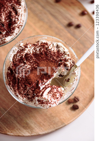 Traditional Italian dessert tiramisu in glasses on white table. Soft focus Traditional Italian dessert tiramisu in glasses on white table. Soft focus 123398436