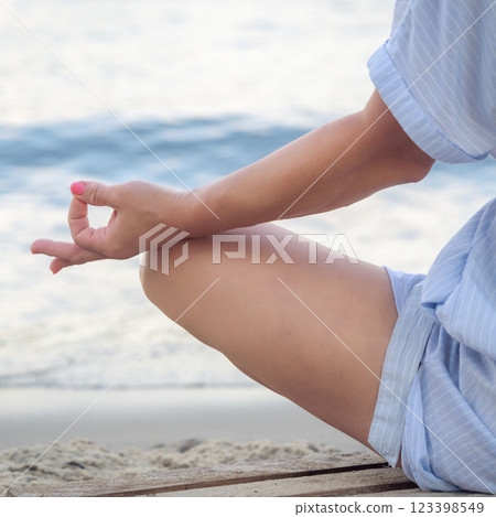 Woman meditating at the sea Woman meditating at the sea 123398549