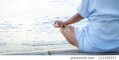 Woman meditating at the sea Woman meditating at the sea 123398553