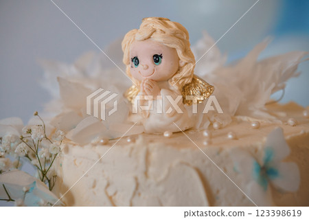 Delightful Angel Figurine on a Decorative Cake 123398619