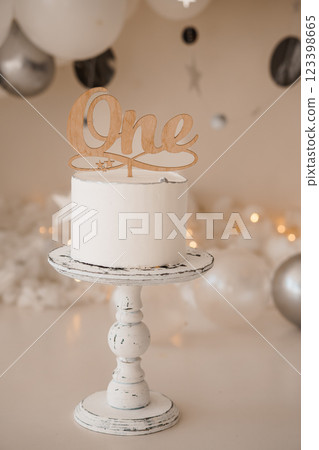 Elegant One-Year Birthday Cake Displayed with Festive Decorations 123398665