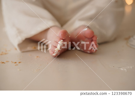 Delightfully Messy Baby Feet Covered in Cake Crumbs and Frosting 123398670