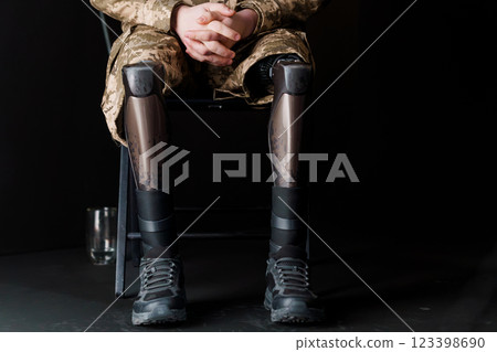 A Soldier in Military Camouflage with Advanced Bionic Leg Prosthesis Resting in a Chair A Soldier in Military Camouflage with Advanced Bionic Leg Prosthesis Resting in a Chair 123398690