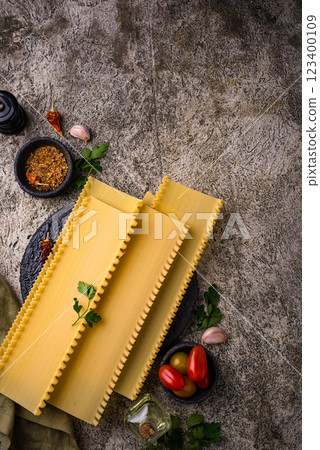 Uncooked lasagna pasta with cooking ingredient Uncooked lasagna pasta with cooking ingredient 123400109