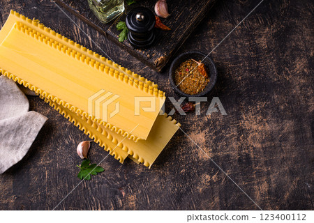 Uncooked lasagna pasta with cooking ingredient 123400112