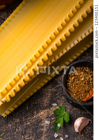 Uncooked lasagna pasta with cooking ingredient 123400151