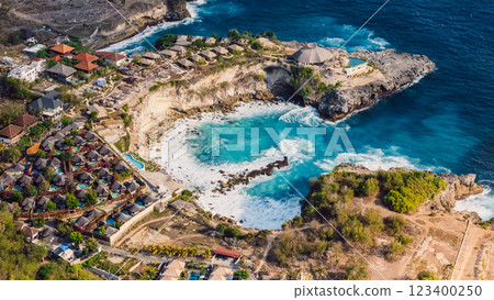 Coastline with blue lagoon on Nusa Ceningan island, Indonesia, drone view of scenic coastline with hotels 123400250
