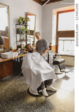 A Stylish and Contemporary Barber Shop Scene Featuring a Client and a Grooming Barber A Stylish and Contemporary Barber Shop Scene Featuring a Client and a Grooming Barber 123401209