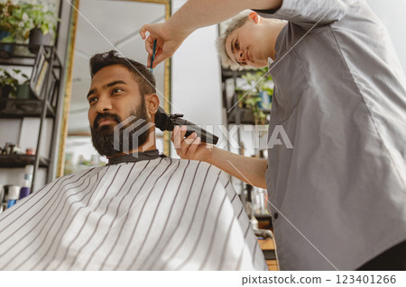 A skilled barber providing a classic gentlemans haircut at a stylish, modern salon setting, A skilled barber providing a classic gentlemans haircut at a stylish, modern salon setting, 123401266