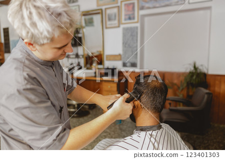 Modern Barber Styling A Skillfully Executed Haircut in Progress with Attention to Detail Modern Barber Styling A Skillfully Executed Haircut in Progress with Attention to Detail 123401303