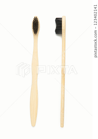 Bamboo wood toothbrush with black brush bristles isolated on white background 123402141