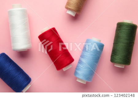 Color sewing threads on pink background 123402148