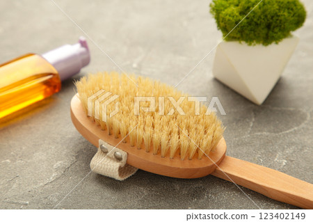 Set of home SPA cosmetic products. Dry Brush and Organic Oil. Anti-cellulite brush for dry body massage. Set of home SPA cosmetic products. Dry Brush and Organic Oil. Anti-cellulite brush for dry body massage. 123402149