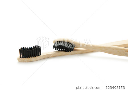 Bamboo wood toothbrush with black brush bristles isolated on white background Bamboo wood toothbrush with black brush bristles isolated on white background 123402153