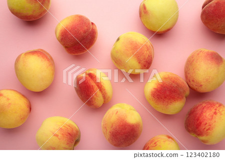 Fresh ripe peaches on pink background, top view. Fresh ripe peaches on pink background, top view. 123402180