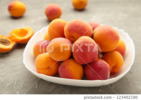 Fresh apricots in the bowl on grey concrete background 123402190