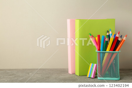 School accessories with books on grey background. Back to school concept. School accessories with books on grey background. Back to school concept. 123402194