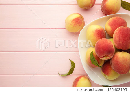 Plate of ripe peaches on pink background. Space for text Plate of ripe peaches on pink background. Space for text 123402195