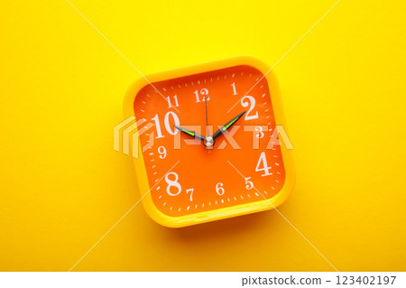 Yellow alarm clock on yellow background with copy space Yellow alarm clock on yellow background with copy space 123402197