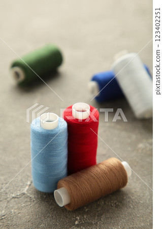 Color sewing threads on grey background 123402251