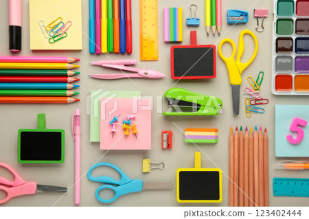 Different stationery on grey background, flat lay with space for text. Back to school 123402444