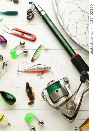 Nikolaev, Ukraine - 08 july, 2022: Fishing rods and spinnings in the composition with accessories for fishing on white background. 123402530