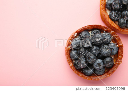Blueberry tartlets on pink background. Homemade tarts with black berries. Blueberry tartlets on pink background. Homemade tarts with black berries. 123403096