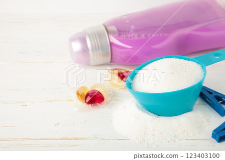 Laundry detergents with washing powder and capsules on white background Laundry detergents with washing powder and capsules on white background 123403100