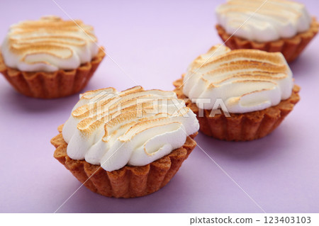 Appetizing lemon cupcakes with white cream on purple background. Holiday, surprise, birthday, Valentine's Day. 123403103