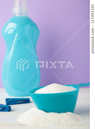 Laundry detergents with washing powder on purple background. Vertical photo Laundry detergents with washing powder on purple background. Vertical photo 123403105