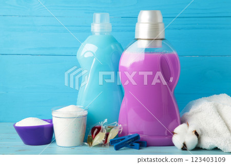 Laundry detergents with washing powder and capsules on blue background Laundry detergents with washing powder and capsules on blue background 123403109