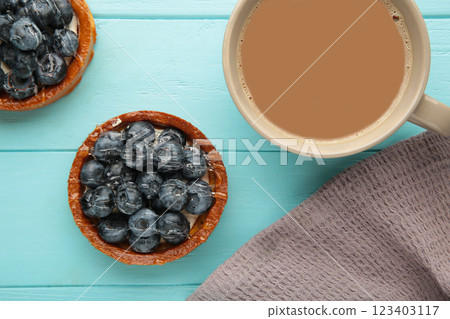 Blueberry tartlets on dark plate with cup of coffee. Homemade tarts with black berries. Blueberry tartlets on dark plate with cup of coffee. Homemade tarts with black berries. 123403117