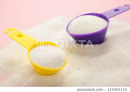 Laundry detergent powder for washing machine and plastic scoop for dosage. Laundry detergent powder for washing machine and plastic scoop for dosage. 123403118