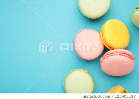 French colorful macarons on blue background. Space for text 123403197